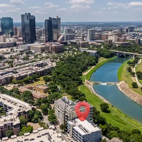 drone shot of the trinity river in downtown Fort Worth with Pin showing the location of the mid-term rental 